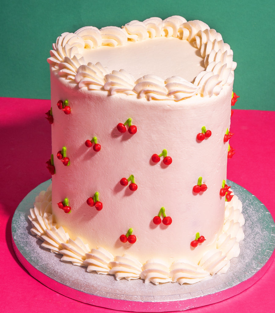 Vinage Heart-Shaped Cake With Hand-Piped Cherry Emojis And White Piping Borders